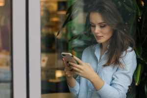 A woman uses her Facebook app to browse content